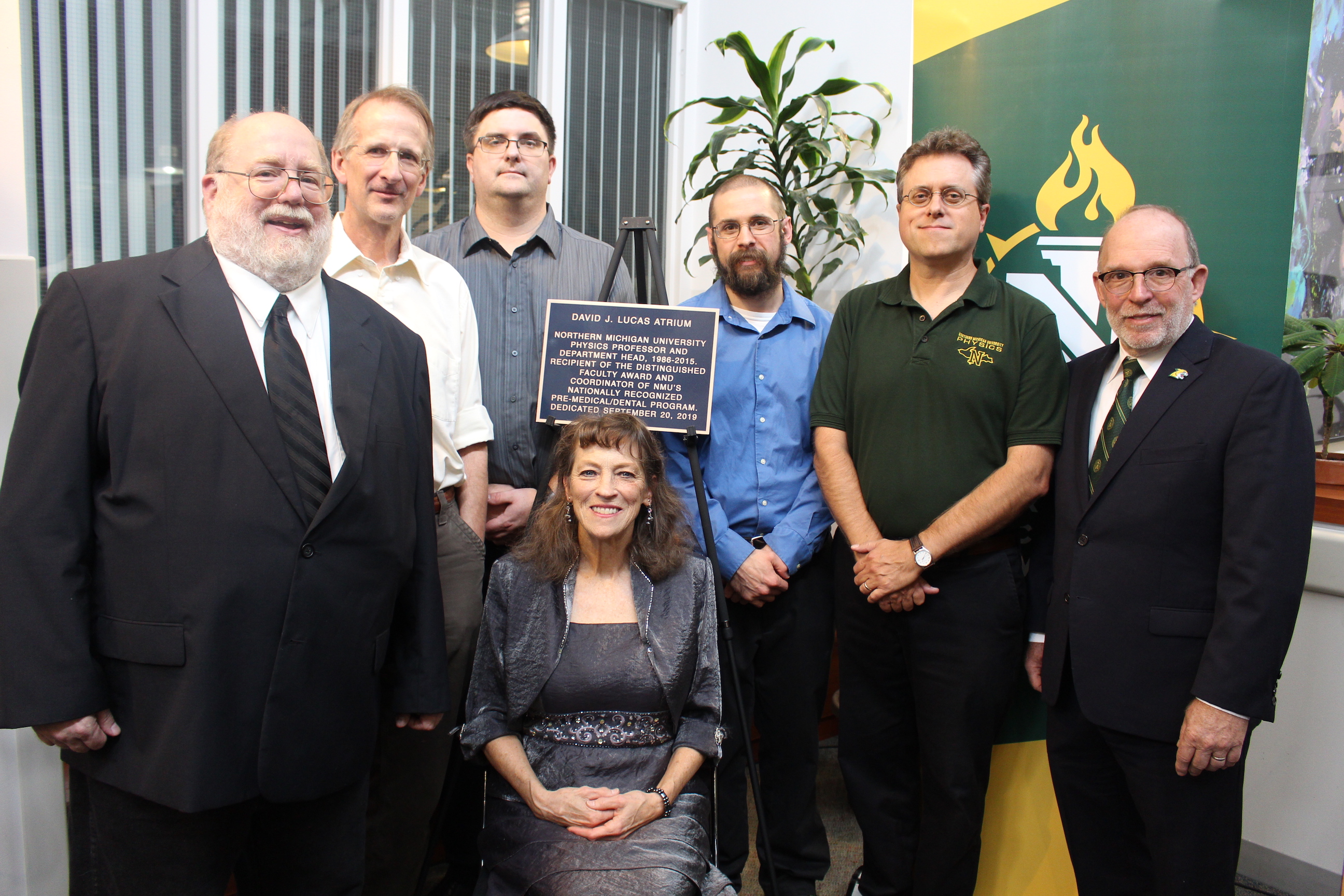 NMU physics faculty Dave Donovan, Mark Jacobs, Will Tireman, Rick Mengyan and Neil Russell with Marsha Lucas and President Fritz Erickson