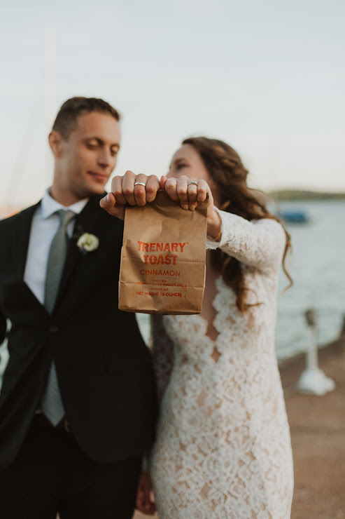 The newlyweds with a symbol of their love and unity (besides the rings): a bag of Trenary Toast.