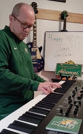 In NMU apparel for the birthday song requested by Alumni Association Board President Jan Haapala.