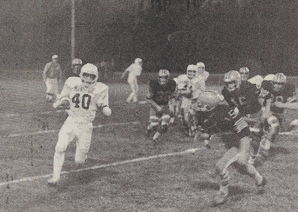 Newspaper photo of Brady running a play during Manistique's 49-0 rout of Rudyard.