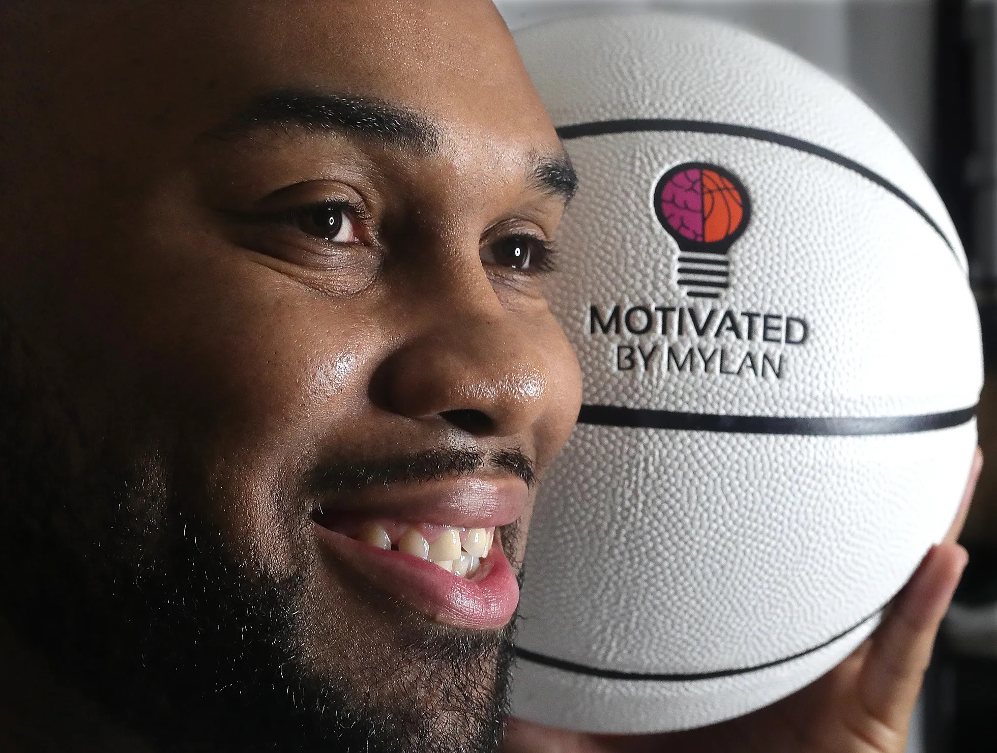 Murphy with a branded basketball (Phil Masturzo, Akron Beacon Journal)