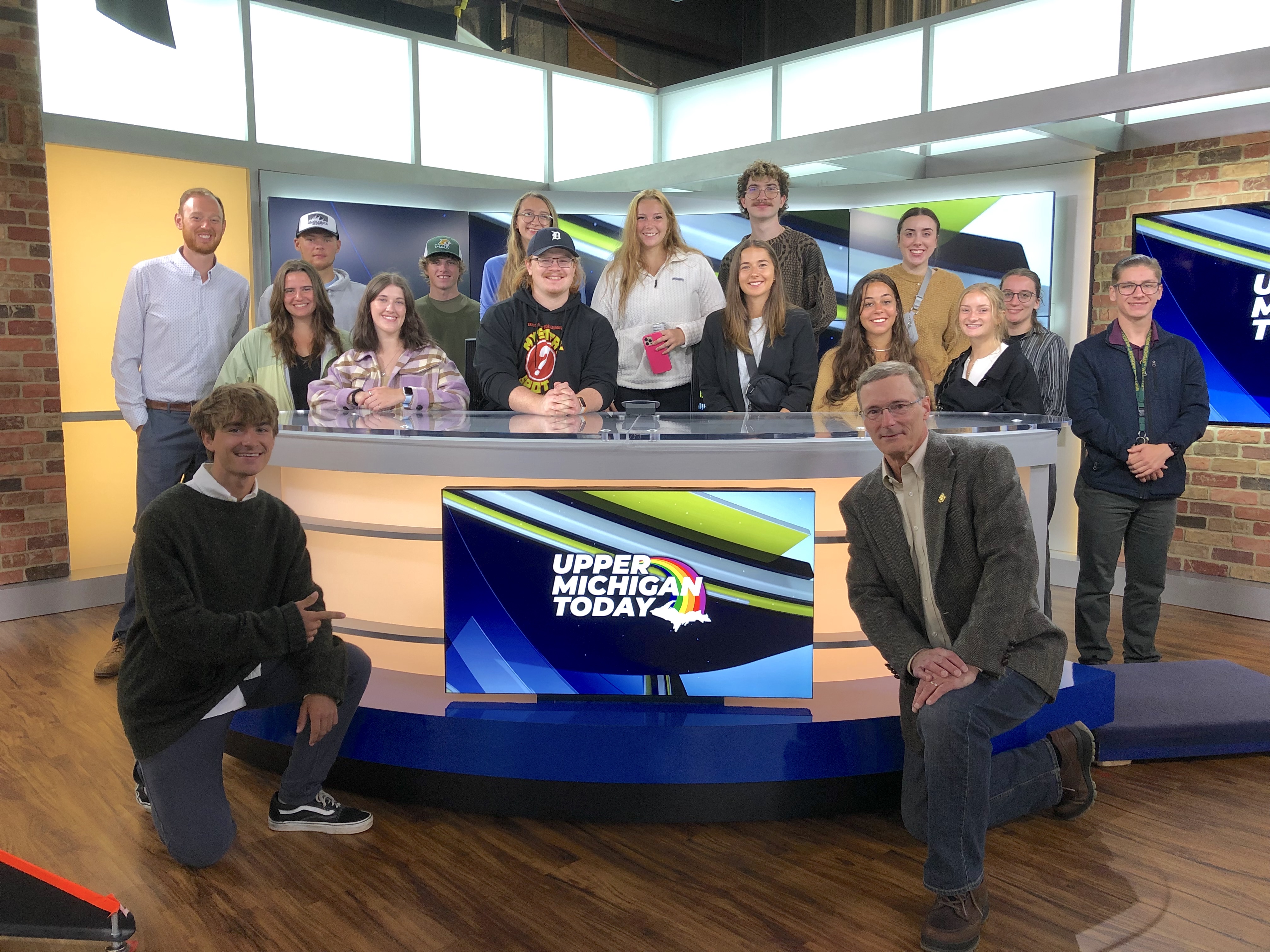 Brady (lower right) and his students on the set of Upper Michigan Today