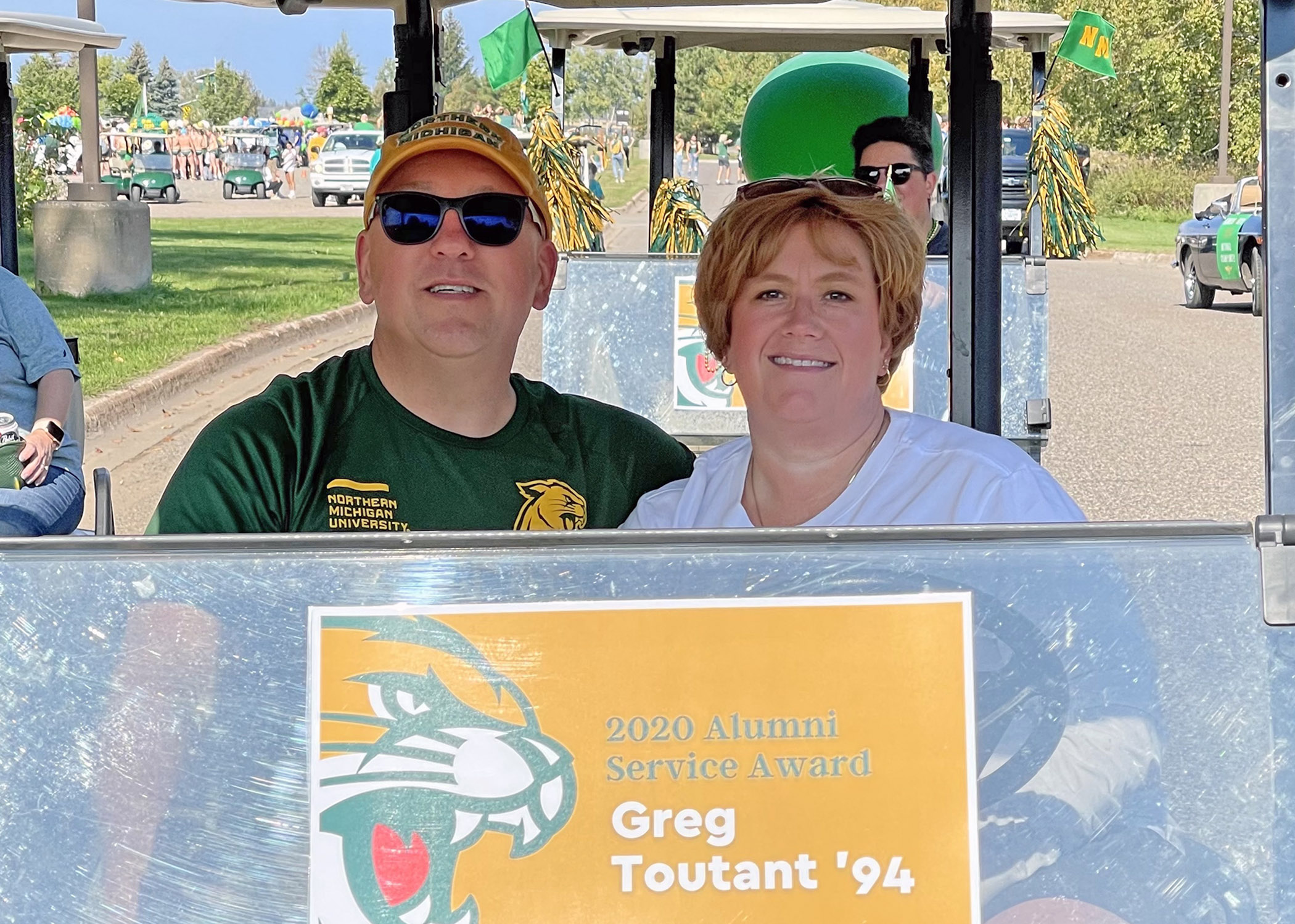 Greg and Heather in the Homecoming parade when he received the Alumni Service Award