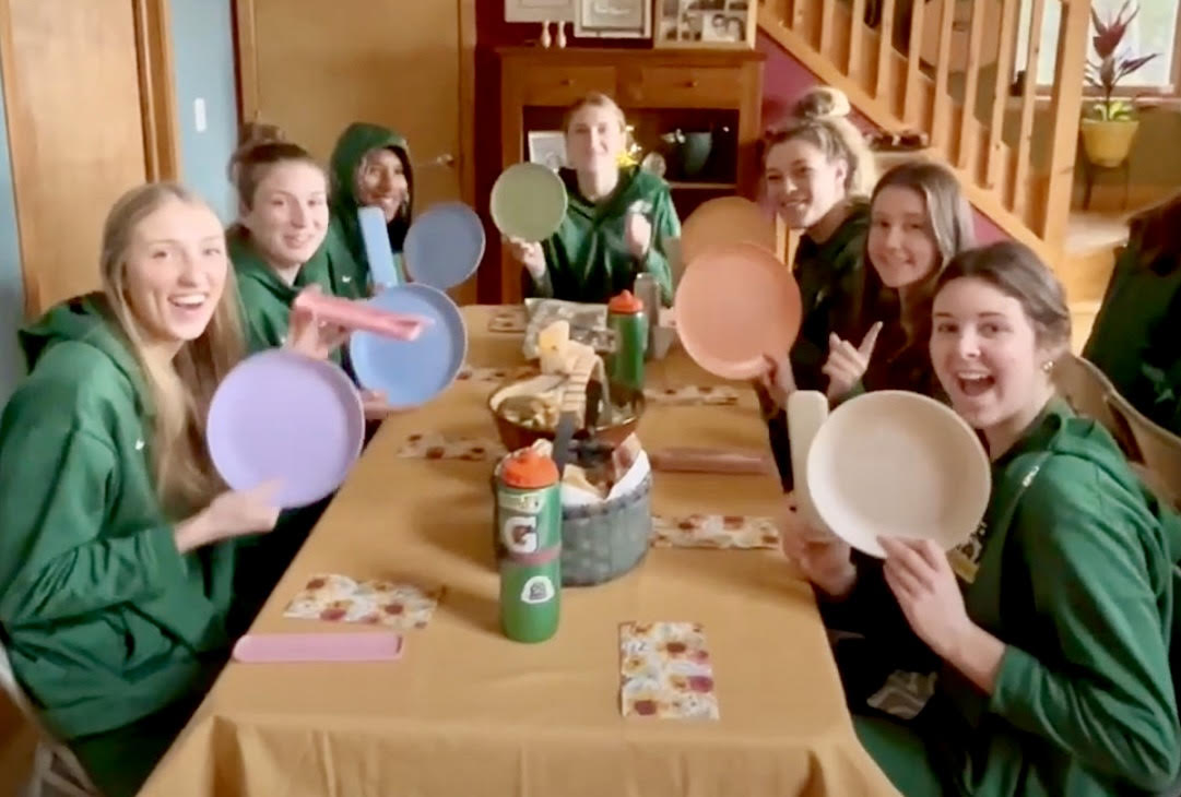 Still capture from the video showing volleyball players with their reusable plates/utensils on a road trip.