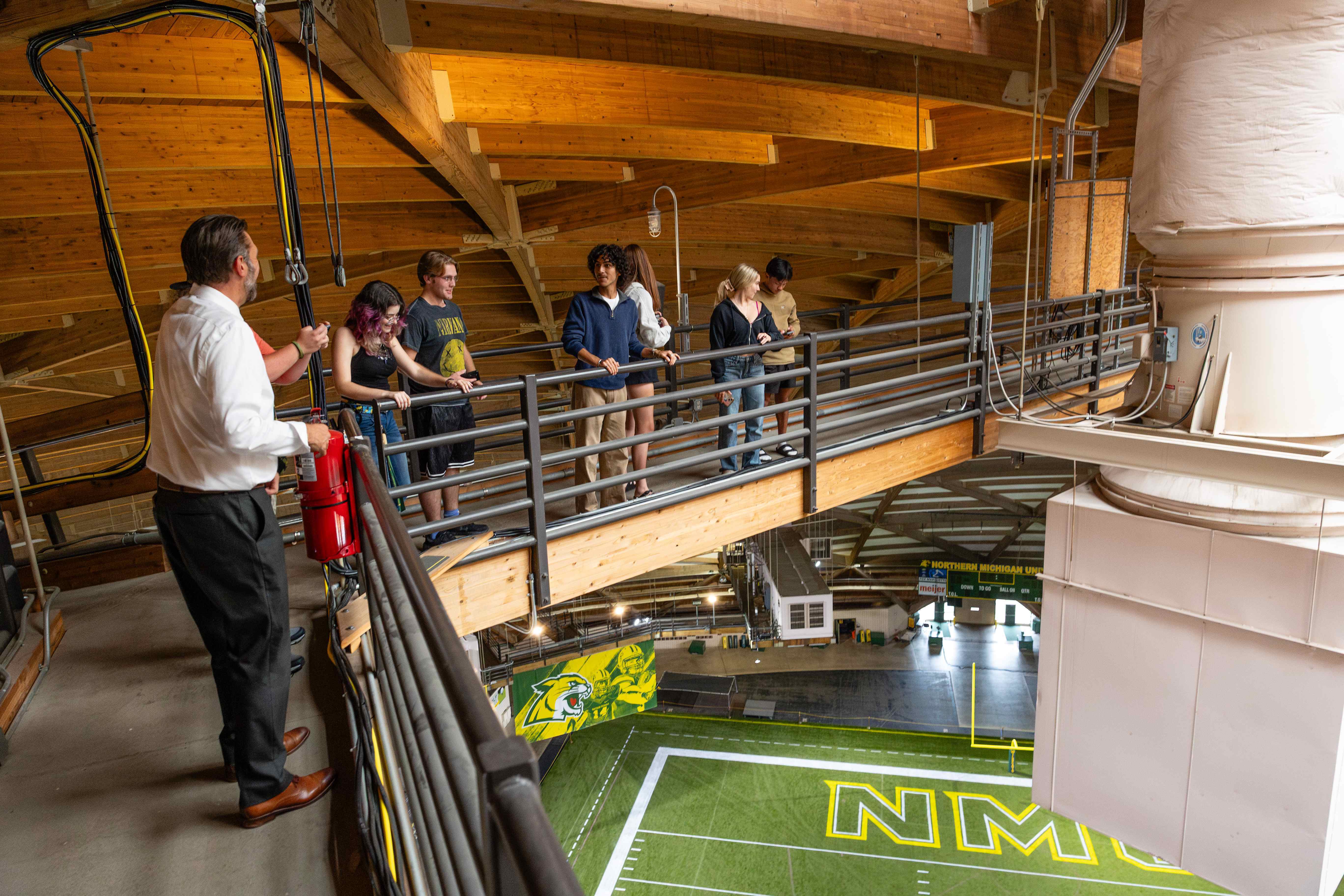 Schultz Fellows on the Superior Dome catwalk above the field. Jeff Korpi, associate vice president of Northern Student Experience (in white shirt) led the tour.