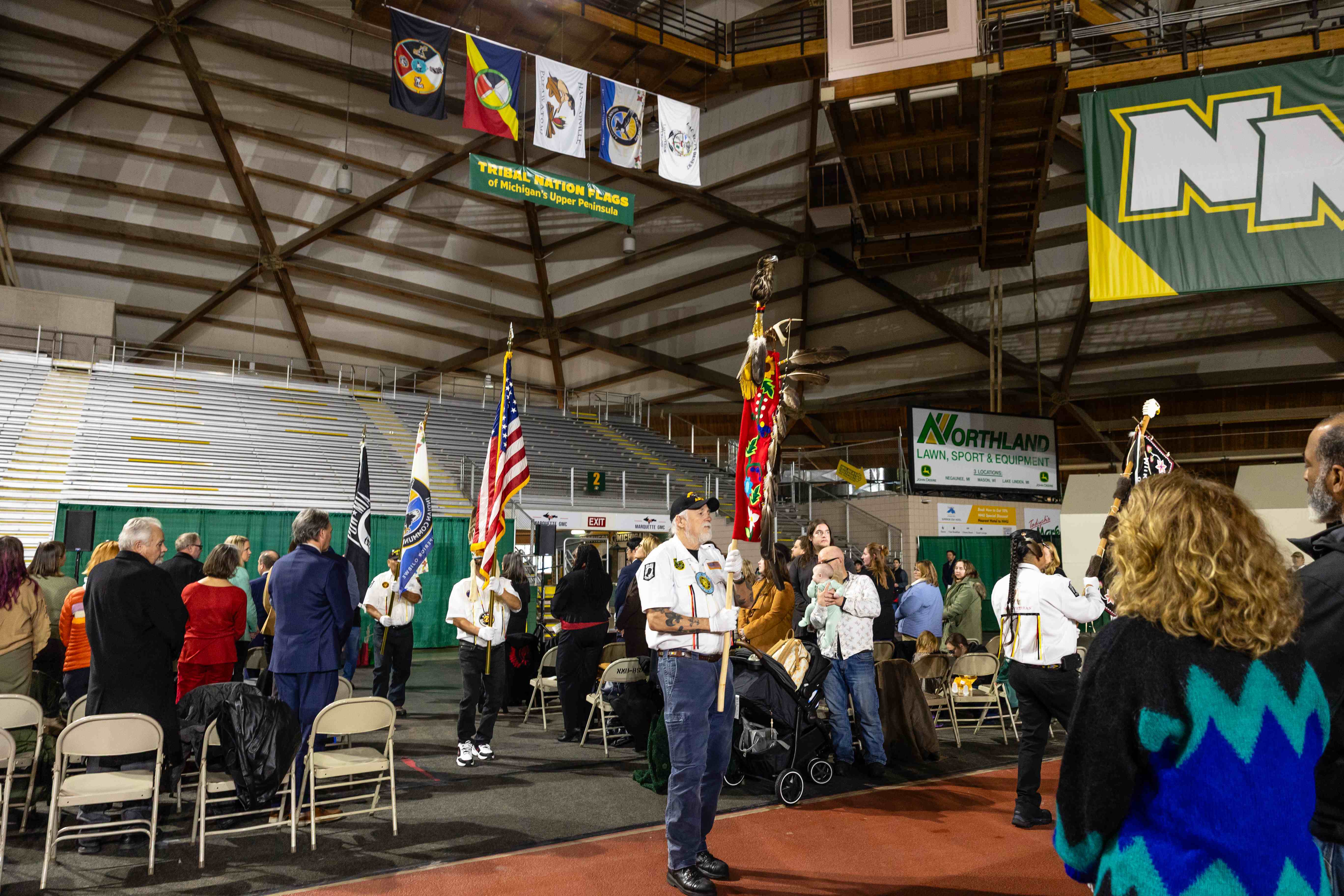The color guard enters beneath the flag display
