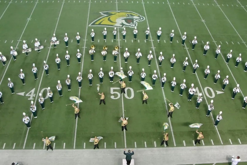 A past photo of Grugin (center, bottom) directing the marching band