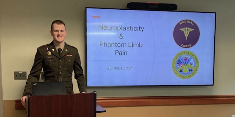 Bilicki delivering a presentation in his military uniform.