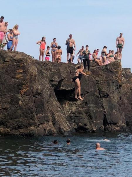 Image of Shawn Robinson-Sobczak jumping off Black Rocks to save someone