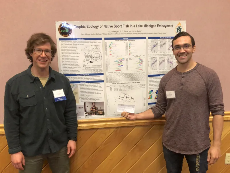 NMU biology professor Brandon Gerig (left) with Whitinger.