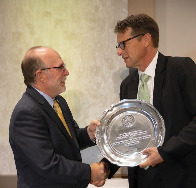 Mommaerts (right) receives his award from NMU President Fritz Erickson