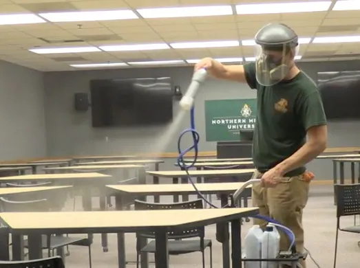 A staff member applies MicrobeCare