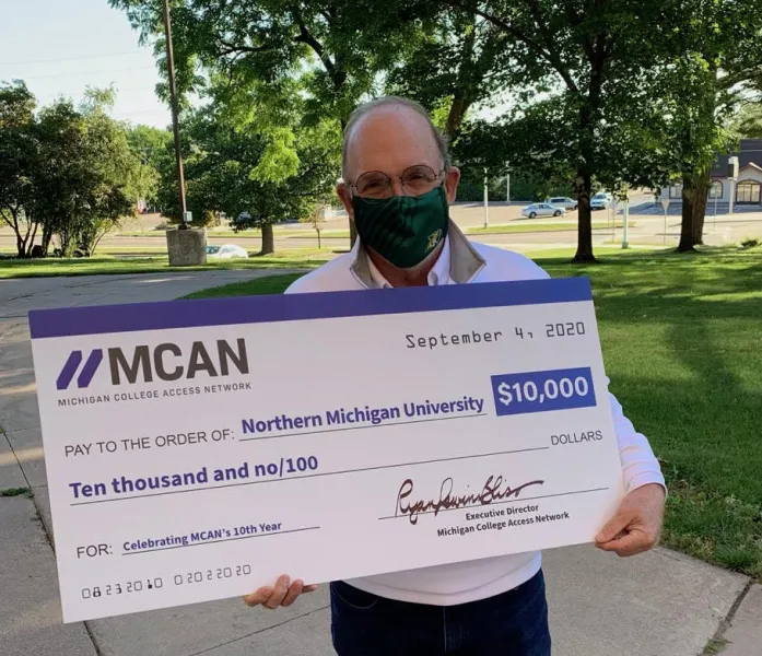 NMU President Fritz Erickson with the ceremonial check