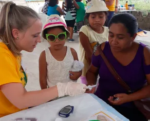 NMU community health graduate Erin Messerschmidt at a community health fair in Belize, May 2019.