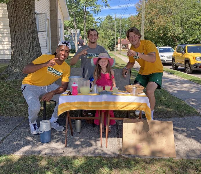 Millie with three of the Wildcat football players who bought lemonade.