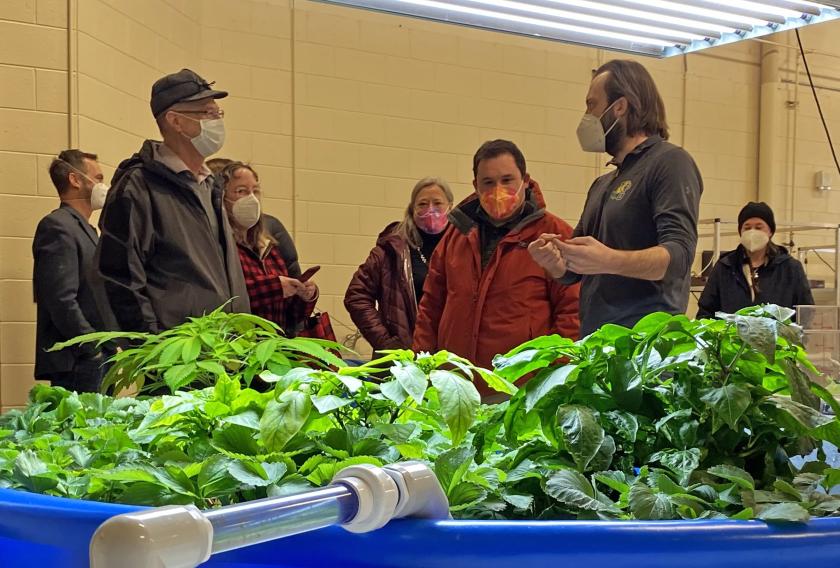 McDowell (front left) listens to NMU Assistant Professor Evan Lucas during a tour of the indoor agriculture lab. (Dave Nyberg photo)