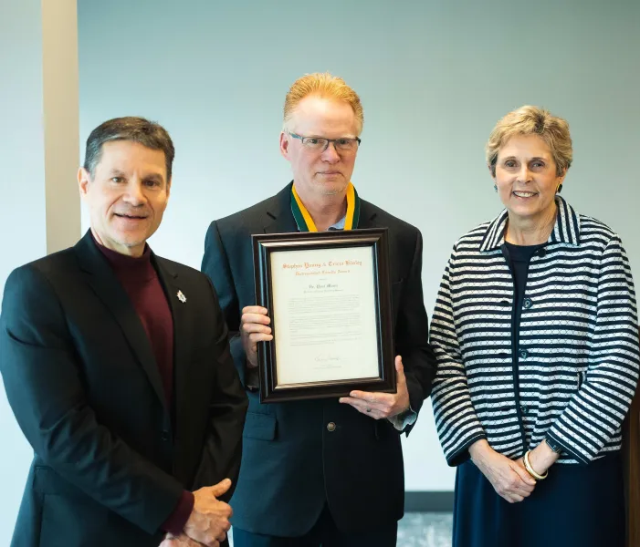 Mann (center) with Interim Provost Dale Kapla and Interim President Kerri Schuiling