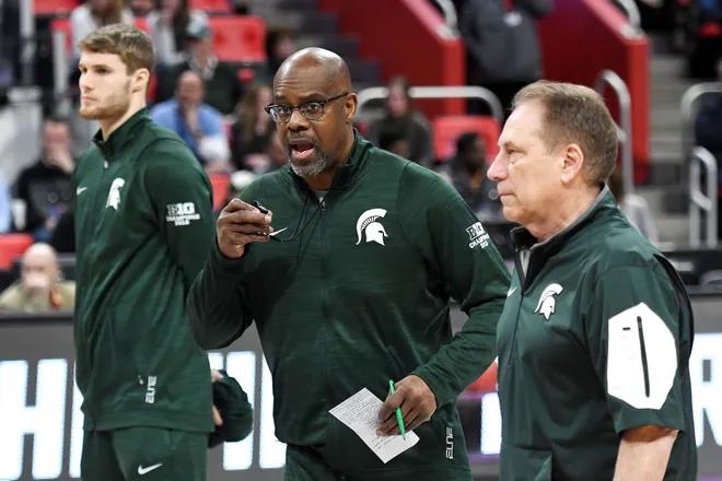 Garland (center) left his spot on Izzo's bench for a period this past season while his son recovered from heart surgery in Cleveland (photo by Nick King/Lansing State Journal).