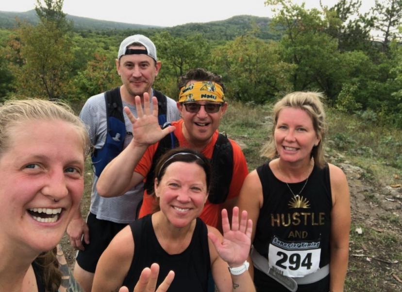 White (front center) with SLEPS colleagues and her husband completing the Four Peaks trail run last summer.