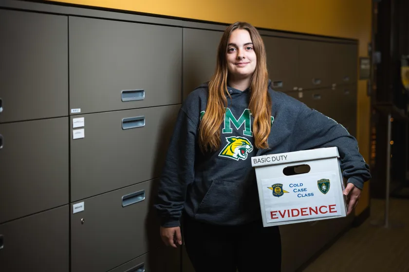 Student Autumn Combs with a box of case materials