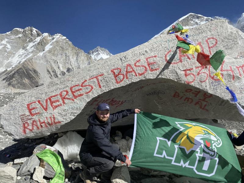 Gonzalez displays an NMU flag upon reaching Everest Base Camp