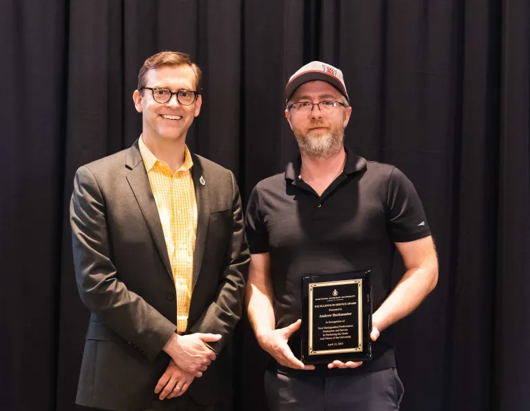 Buckmaster (right) with President Brock Tessman