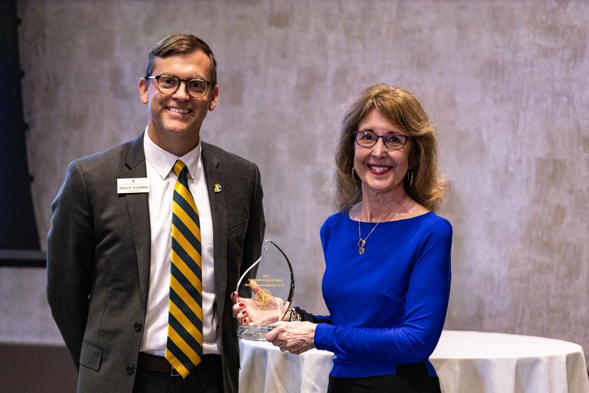Dr. Ellen Narotzky Kennedy accepts the Distinguished Alumni Award from NMU President Brock Tessman