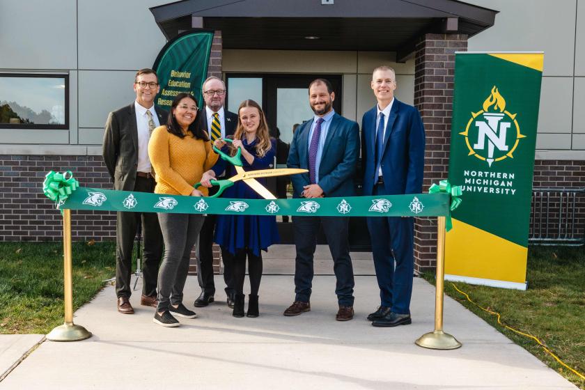 (From left): NMU President Brock Tessman, master's student and Registered Behavior Technician Cheyenne Nutlouis, Board Chair Steve Young, Zoe Broadus, Director Jacob Daar and Adam Prus, chair of the Department of Psychological Science.