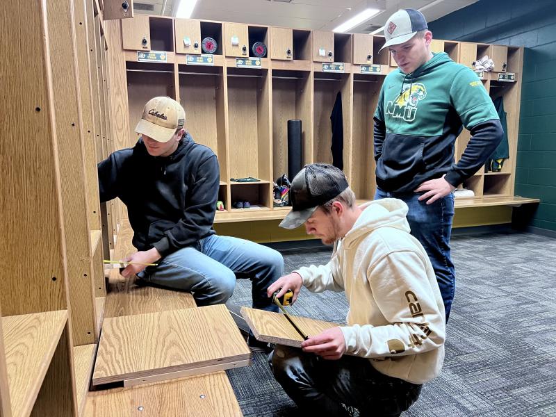 (From left): Kyle Sahr, Trent Kantola and Luke Pettinger installing locker shelves.