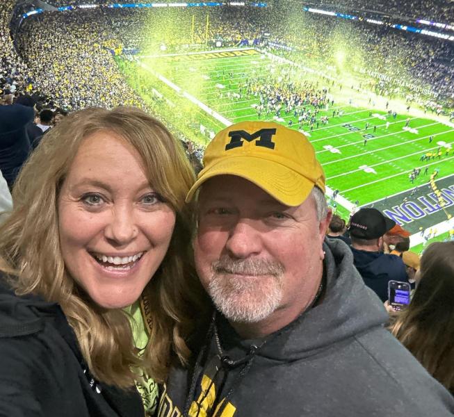 Nanette Hanson cheering on Michigan at the game (Facebook photo)