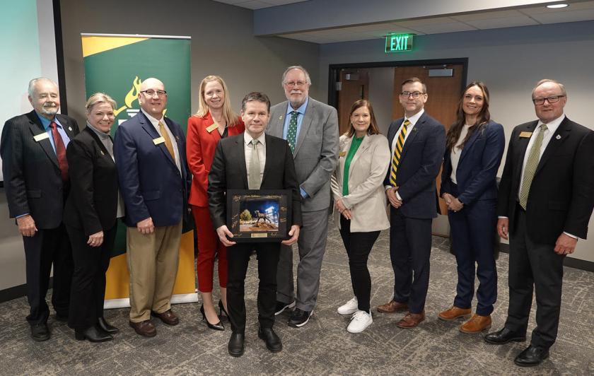 Interim Provost and VP for Academic Affairs Dale Kapla received a special recognition from the board for his service. He is pictured front and center with (back row from left): Trustees Steve Lindberg, Alexis Hart, Greg Toutant, Missie Holmquist, Greg Seppanen and Lisa Fittante, NMU President Brock Tessman, and Trustees Brigitte LaPointe-Dunham and Steve Young.