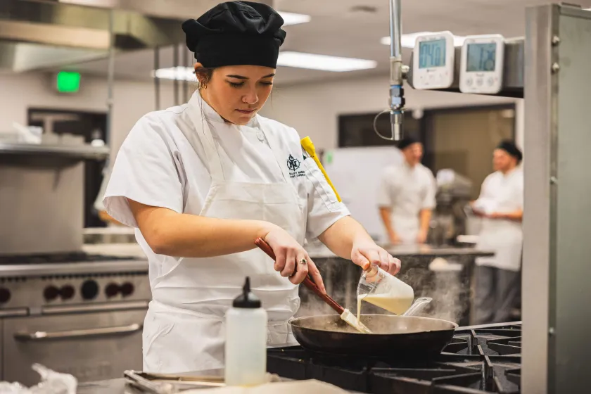 Hospitality Leadership student preparing food (NMU stock photo)
