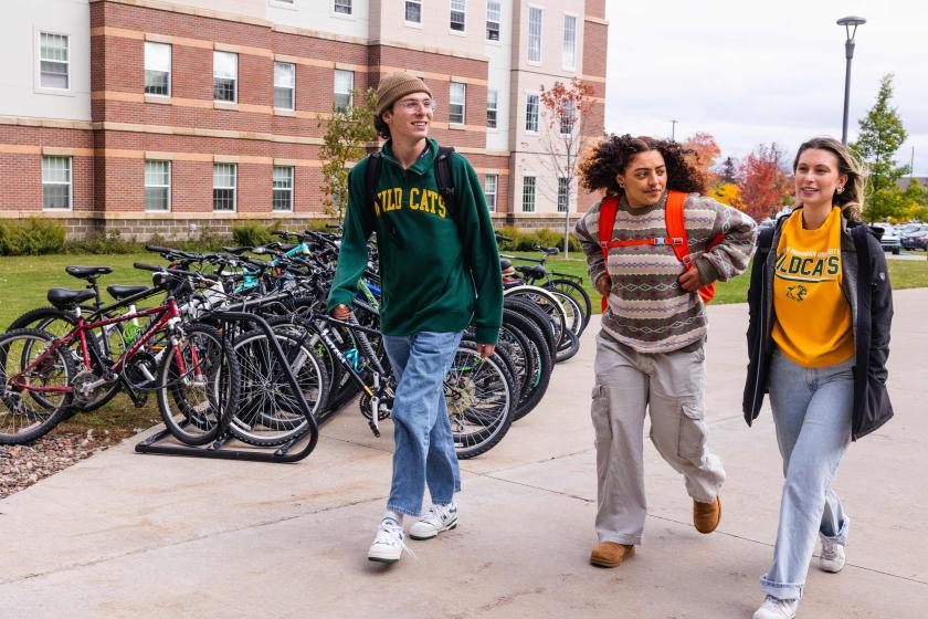 NMU stock photo of students walking on campus