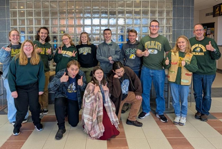 Members of the three NMU Quiz Bowl squads pictured with coach Michael Joy at right.