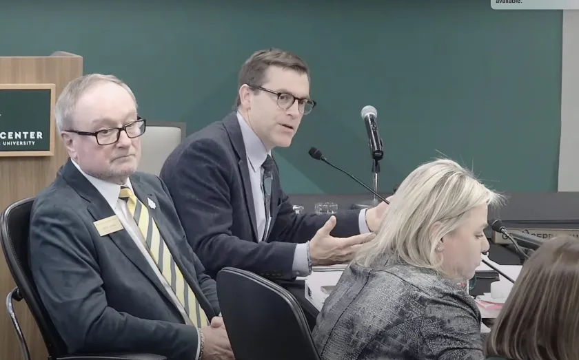 NMU President Brock Tessman (center) at the board meeting with Chair Steve Young and Vice Chair Alexis Hart