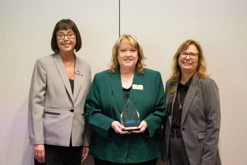 NMU Center for Rural Health Director Elise Bur (center) is pictured holding the Nonprofit of the Year Award with Holly Peoples (left) and Debb Brunell, both of Upper Peninsula Michigan Works!, a UPEDA member