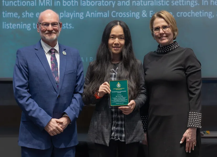 Assistant Professor Lin Fang (center) with Liz Wuorinen, dean of the College of Health Sciences and Professional Studies (left) and Provost Anne Dahlman