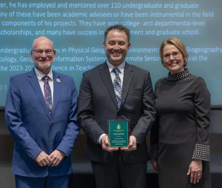 Assistant Professor Adam Naito (center) with Robb Winn, dean of Arts and Sciences, and Provost Anne Dahlman