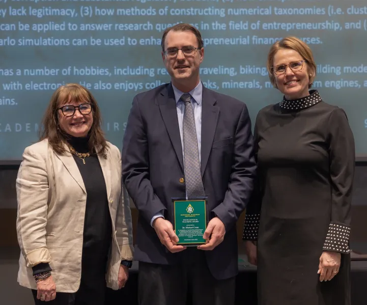 Michael Crum (center) with College of Business Dean Carol Johnson (left) and Provost Anne Dahlman