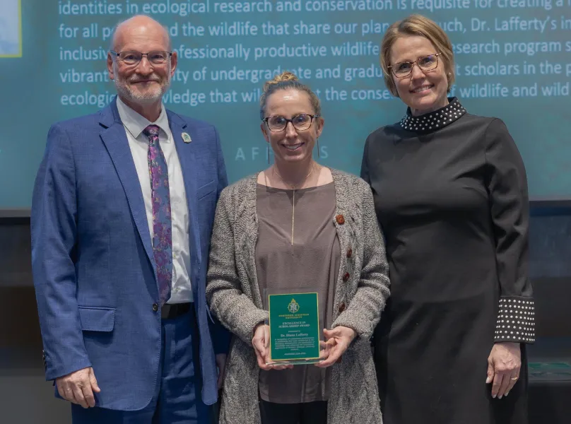 Associate Professor Diana Lafferty with Rob Winn, dean of Arts and Sciences, and Provost Anne Dahlman