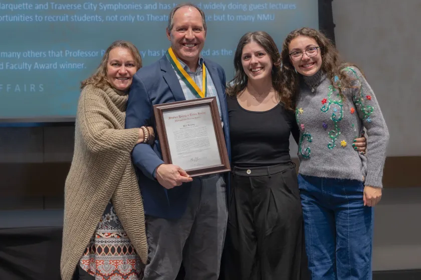Truckey wearing his award medal and surrounded by his family