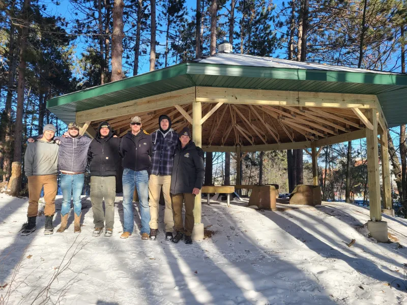 Construction management students in front of the new pavilion they built on campus.