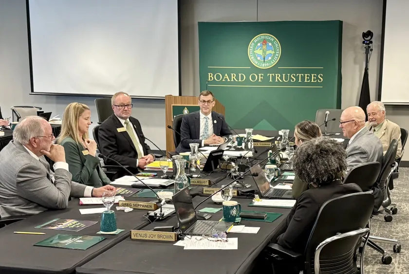 President Brock Tessman (back left) participates in his final NMU Board of Trustees meeting.