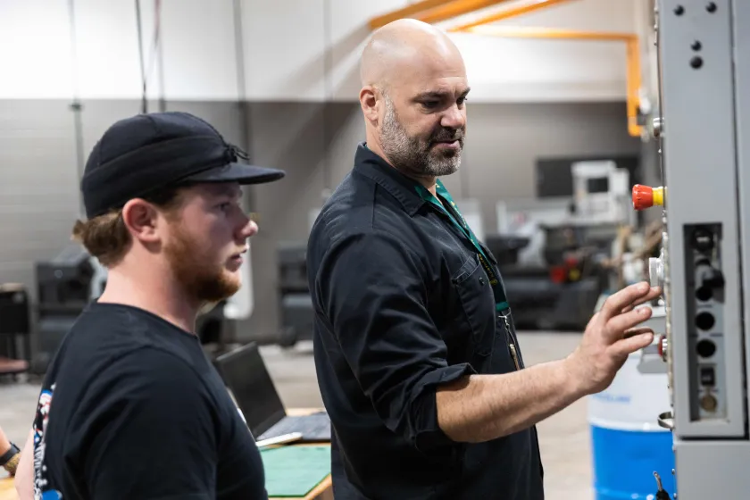 NMU Engineering Technology Professor Cale Polkinghorne with a student