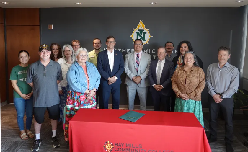 Bay Mills Community College President Duane Bedell is pictured center, between former NMU President Brock Tessman and current Interim President Gavin Leach at the late June signing ceremony on campus, which was also attended by representatives of NMU's Center for Native American Studies and School of Education.