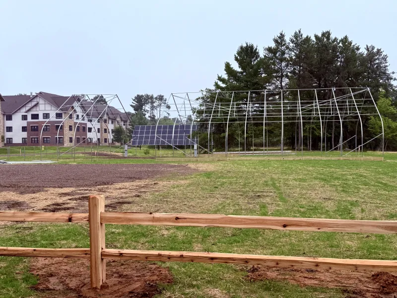 A portion of the Woodland Park site, with the relocated solar array (formerly near the athletic complex) in the back, and the frame for the Hoop House (formerly outside Jacobetti).