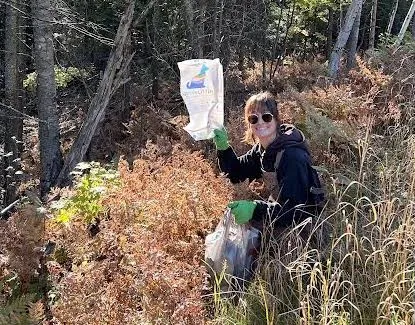 Rosie Mousseau picking up trash along County Road 550