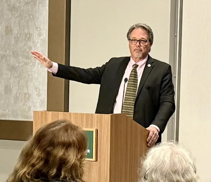 Olsen addressing attendees at the university forum.