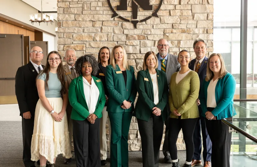 Front row (from left): Delany Frank, Outstanding Graduating Senior; Trustees Venus Joy Brown, Missie Holmquist and Lisa Fittante; Halle Johnson, Outstanding Graduating Senior; and Laura Clarkston, Outstanding Global Campus student. Back row (from left) Trustees Greg Toutant, Steve Lindberg, Brigitte LaPointe-Dunham and Greg Seppanen; President Chris Olsen. Not present: Adam Nesbit, Summer Morrison and Dan Atkins.
