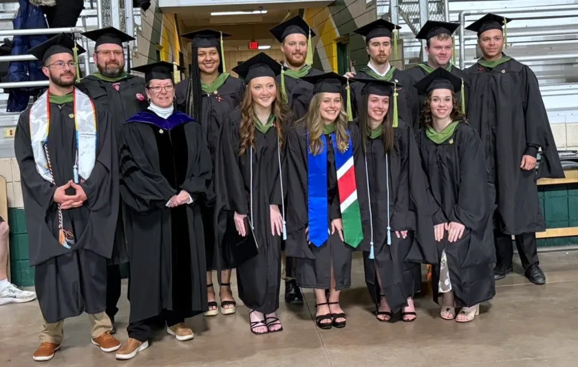 Rochester (third from left) with faculty colleagues and May 2026 athletic training graduates.